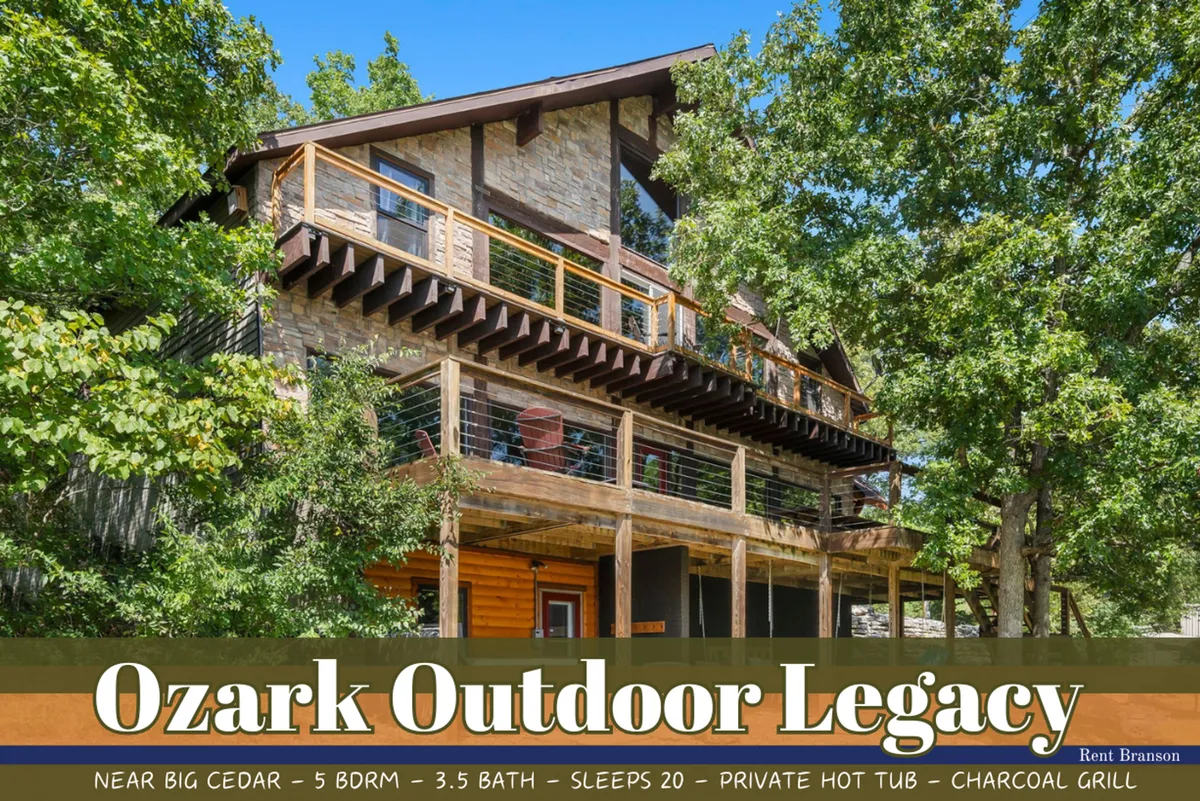 This image showcases the spacious exterior of a secluded single-family home nestled in lush Ozark greenery. A large wooden deck wraps around the stone facade, featuring comfortable seating areas perfect for gatherings, a grill for outdoor cooking, and a glimpse of a private hot tub ideal for unwinding. The setting feels private and surrounded by nature, with the home inviting guests to connect, relax, and enjoy tranquil views.